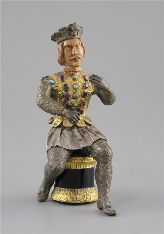 An Austro-Hungarian gilt and white metal figure of a seated knight, with jewelled decoration and hardwood head, height 11.5cm